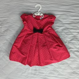 Stunning red and black polka dot dress with a beautiful black bow. My daughter only got to wear this once for around 2 hours so it's good as new. This is beautiful as a gift or even for your princess to wear.  It is fully lined.

6 month old from Carters, it was a gift from Canada.