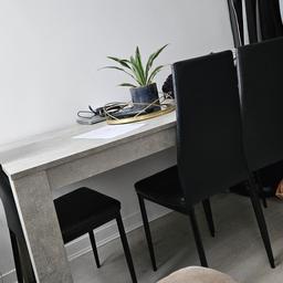 Stone grey effect and black leather chairs. In good condition - table size 140 x 80 x 75cm