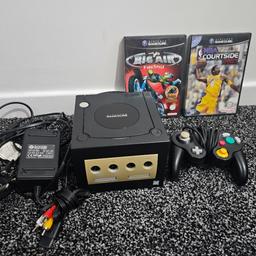 Nintendo gamecube Black 
av and power cable 
 1 controller 
2 games

front panel discoloured but works well