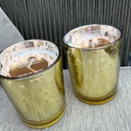 2 heavy glass candles.shiny gold containers with Christmas tree etched on glass.smell amazing cinnamon &Ginger.Height 10cm.lovely quality from House Of Fraser Been £8.00 each.selling both for £12.00.would make lovely gifts