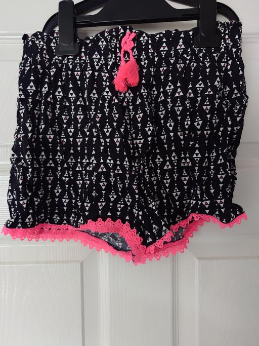  — Girls black patterned shorts size 10-11 years