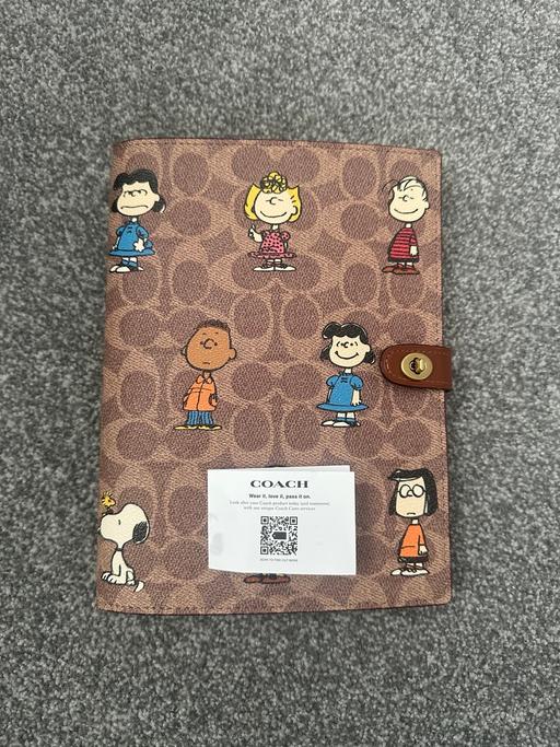  — coach peanuts notebook limited