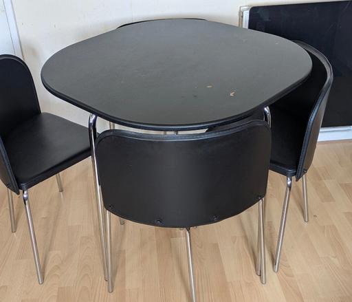  — Black round table with four curved chairs