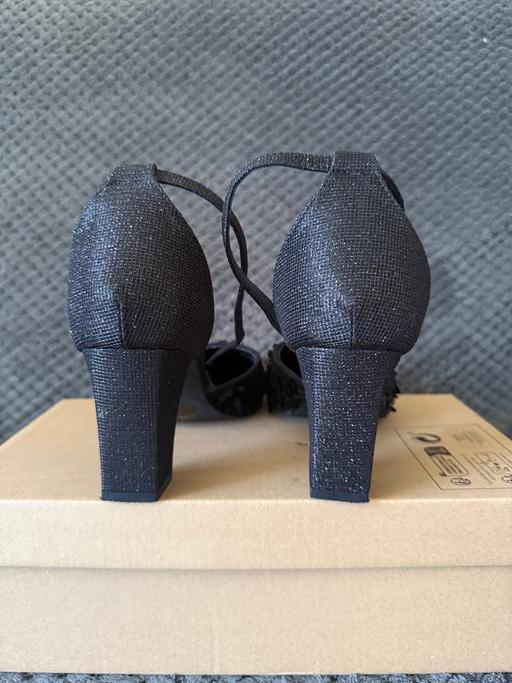  — Women’s black sequin heeled shoes.