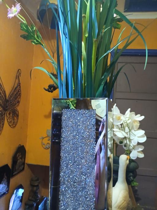 — mirred plant pot with flowers
