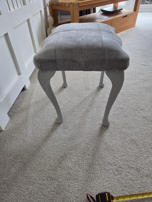  — Grey cushioned upholstered stool