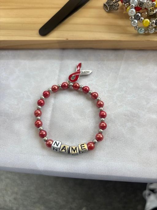  — Red awareness bracelet