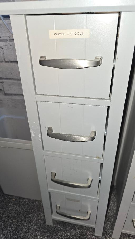  — 2 grey cabinets with 4 drawers. 