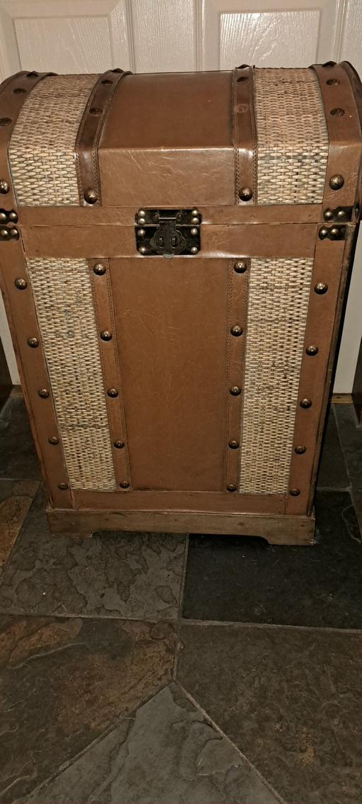  — Tall wooden storage chest.