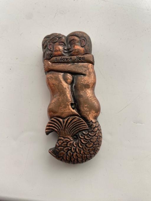  — Vintage lighter mermaid and merman kissing . 