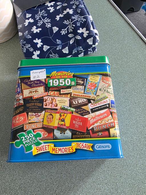  — jigsaw puzzle in a tin