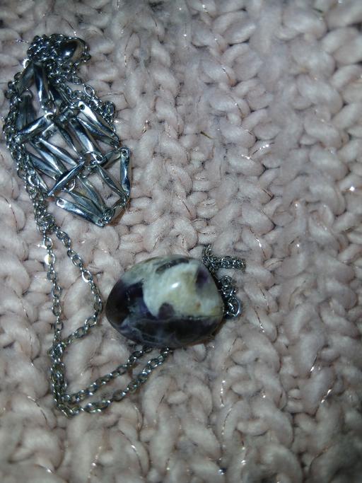  — A rolling stone and a s/steel chain 'cage'.
