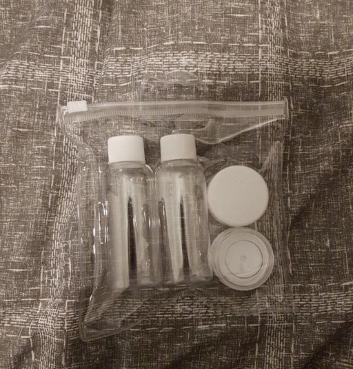  — small clear travel bag and bottles