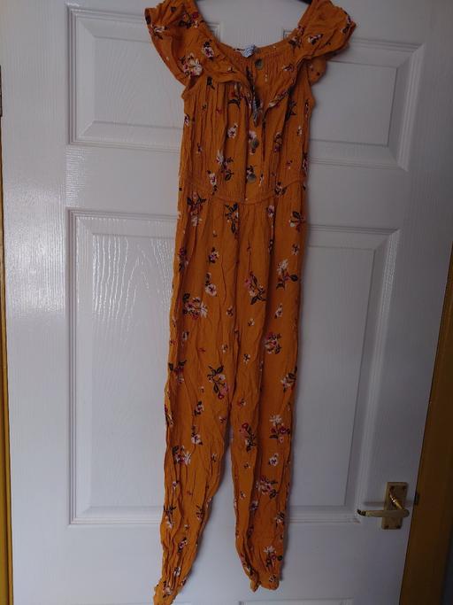  — Girls yellow floral jumpsuit size 9-10 years
