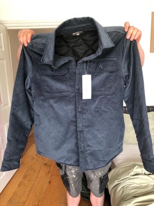  — Navy blue medium men’s jacket.