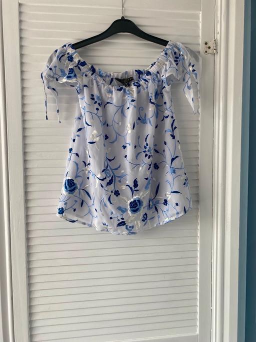  — Blue and white top with flowers