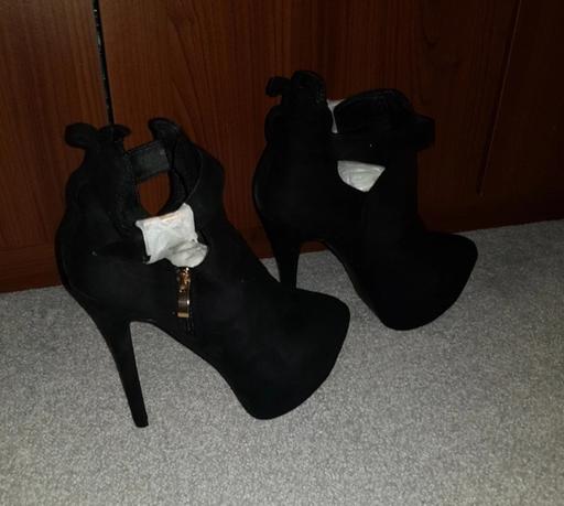  — Black heeled ankle boots