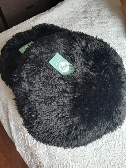  — 2 black round fluffy cushions