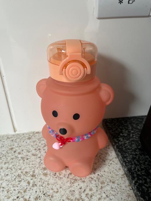  — Bear drinking beaker