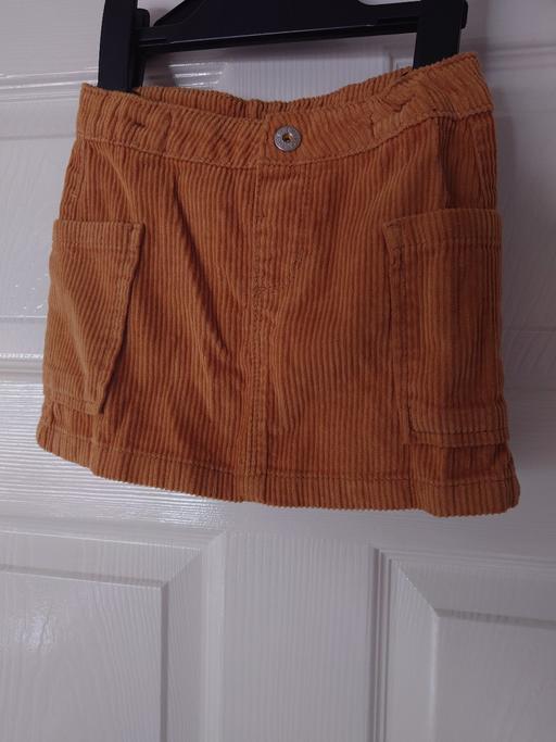  — Girls orange corded skirt size 12-18 months