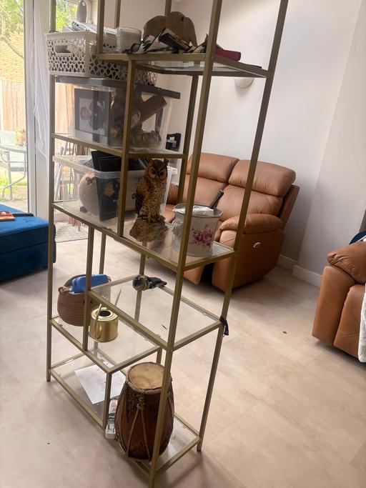  — Gold and glass display unit