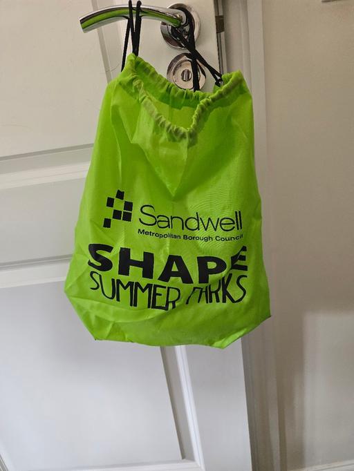  — green drawstring bag and bottle - new