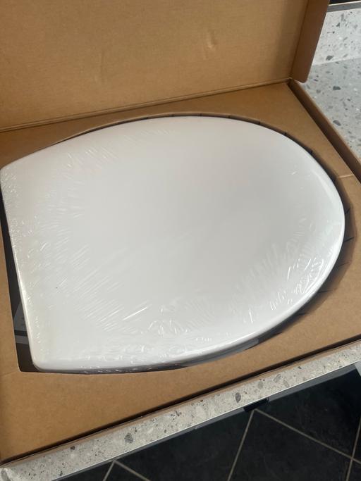  — Grey or white toilet seat
