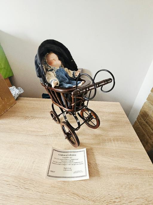  — Collectable porcelain doll and pram.