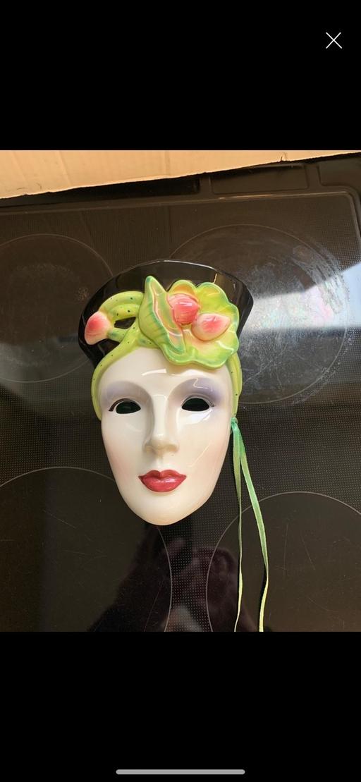  — Wall hanging face mask