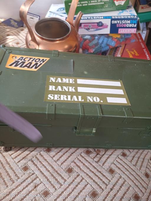  — action man box with hats cloths