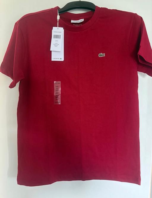  — Lacoste