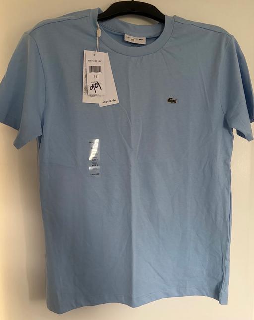  — Lacoste