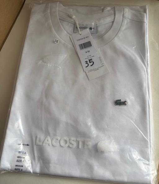  — Lacoste