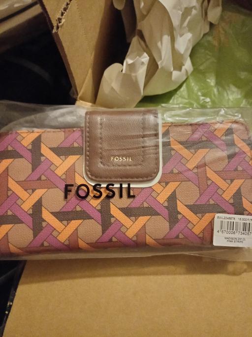  — purse by fossil in wrapper was £100