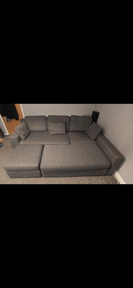  — Grey sofa can be used as a sofa bed.