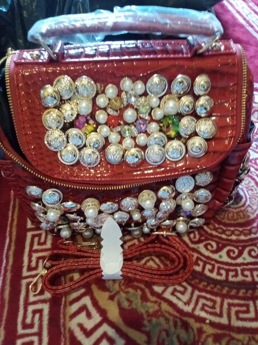  — Red pearl gems button bag