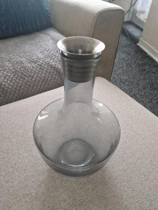 — Elegant glass decanter with a metal spou