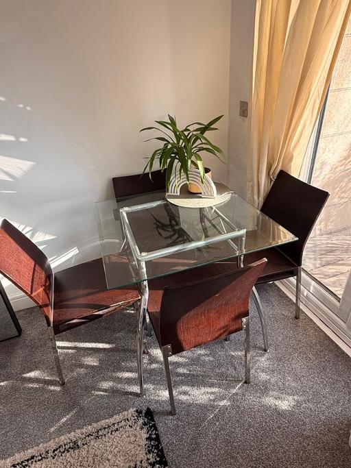  — Glass dining table and 4 chairs