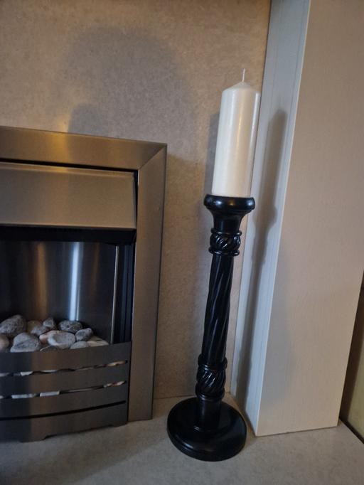  — Large black candle stick & new candle