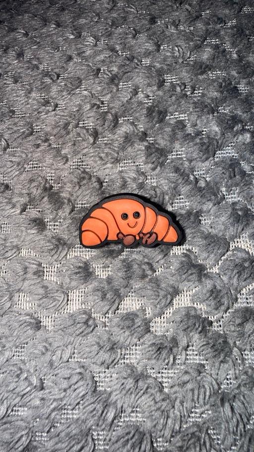  — Croissant inspired croc charm