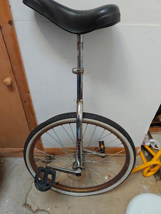  — Black unicycle seat with adjustable post.