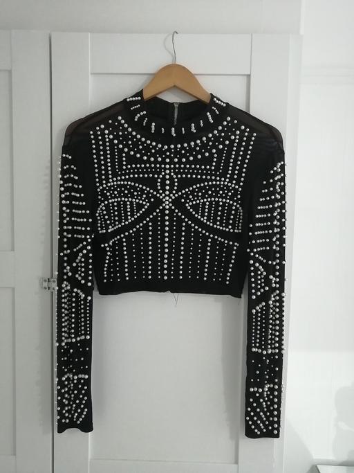  — women's size 10-12 black pearl top
