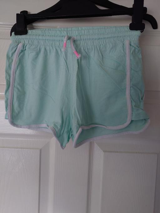  — Girls light green shorts size 11/12 years