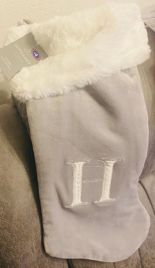  — Grey Christmas stocking with letter H on