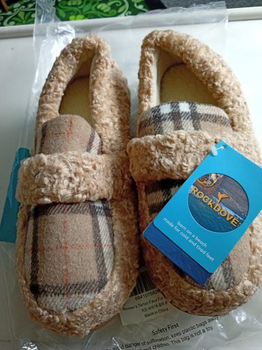  — new pair of ladies moccasins size 7