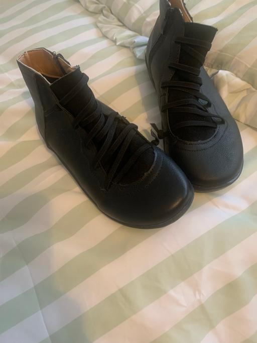  — Black leather ankle boots