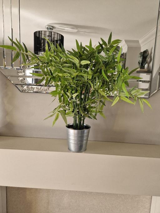  — large artificial plant in a metal plant pot