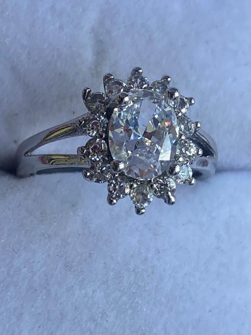 — unmarked silver cubic zirconia cluster ring.