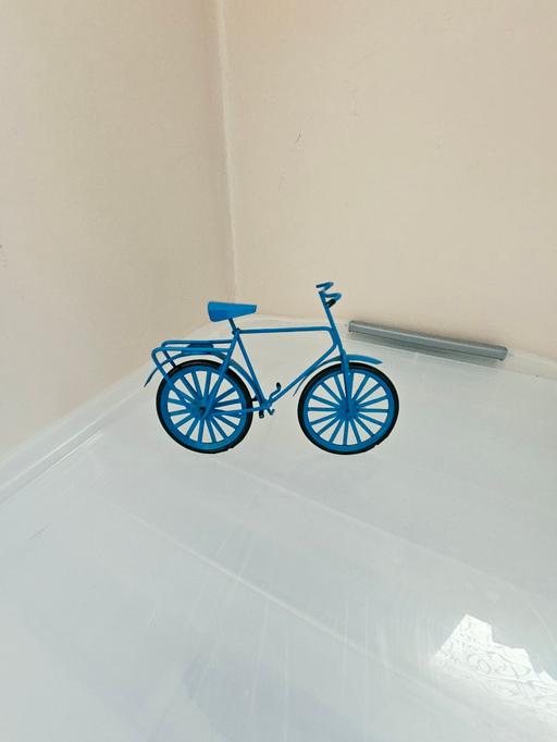  — Metal bike ornament..