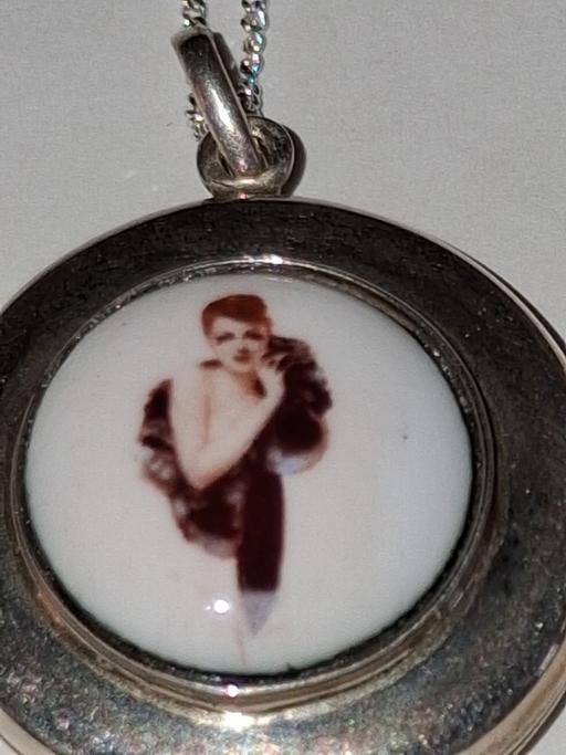  — Solid silver locket and chain.